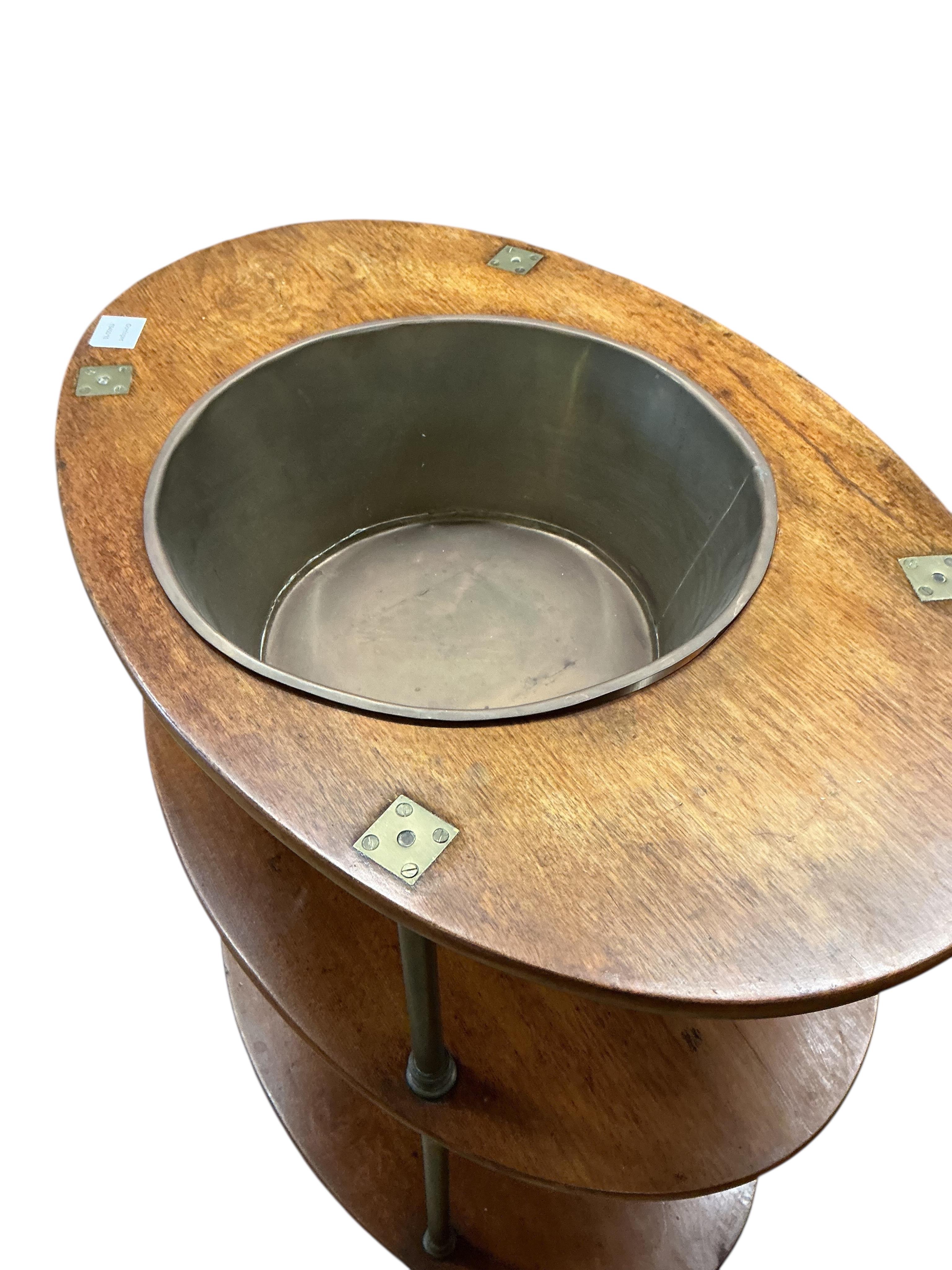 A 19th century oval mahogany and brass three tier campaign ship's wash stand, width 74cm, depth 49cm, height 84cm